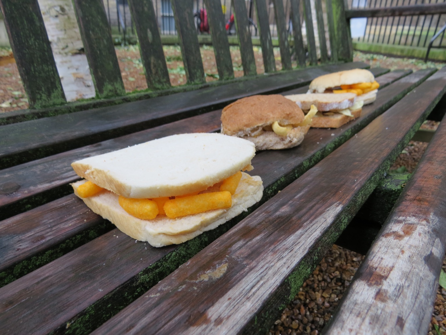 Four sandwiches on park bench, Wotsits sandwich at front