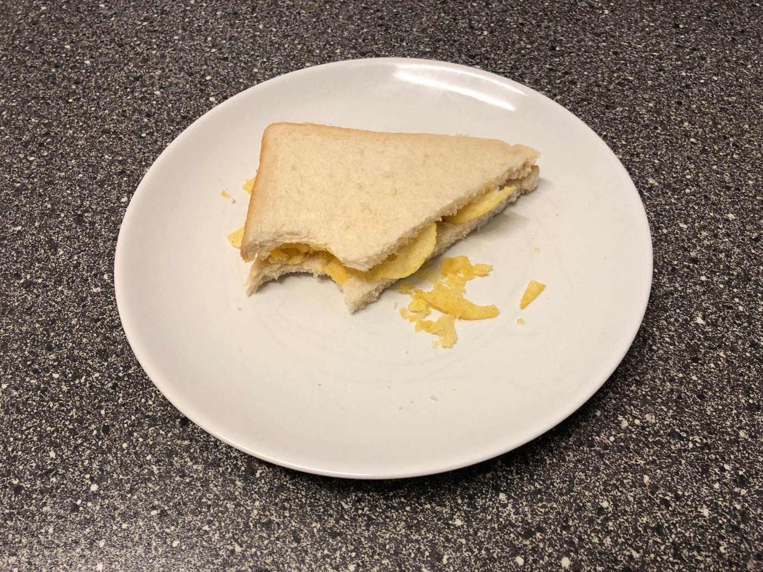 Diagonally-cut crisp sandwich with a bitten corner