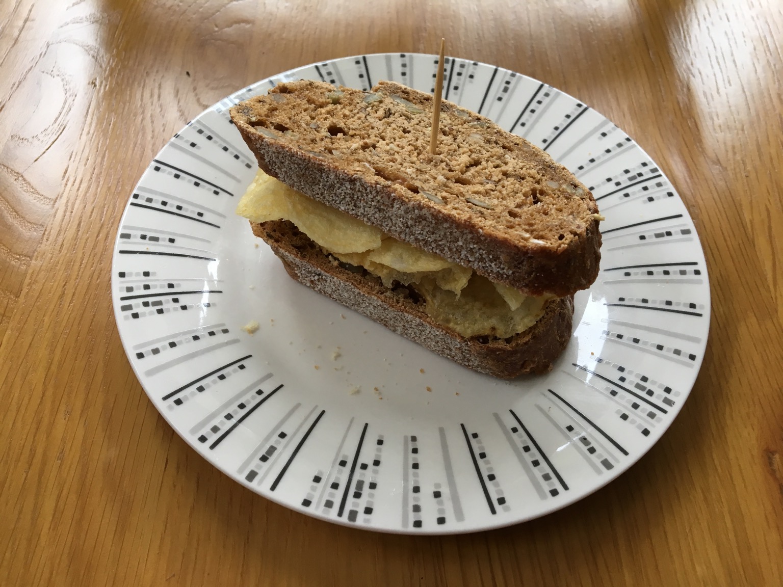 Small brown crisp sandwich with cocktail stick