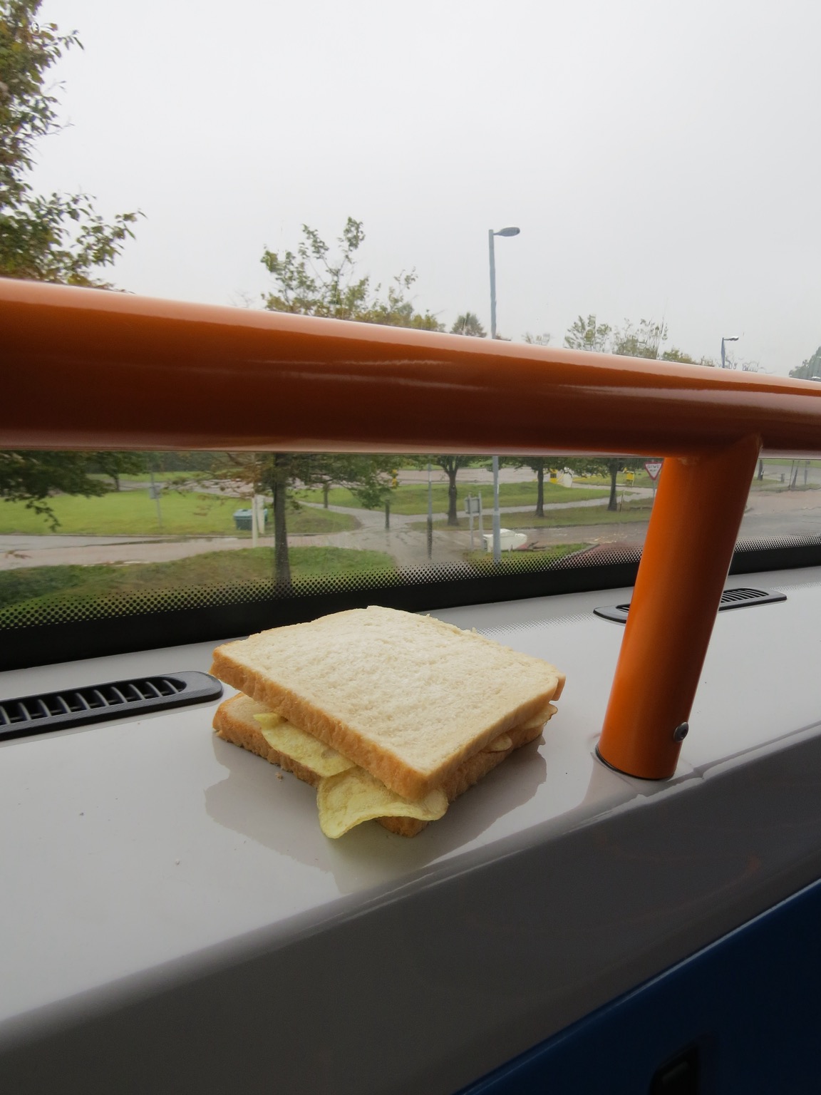 White crisp sandwich placed by the window of a bus