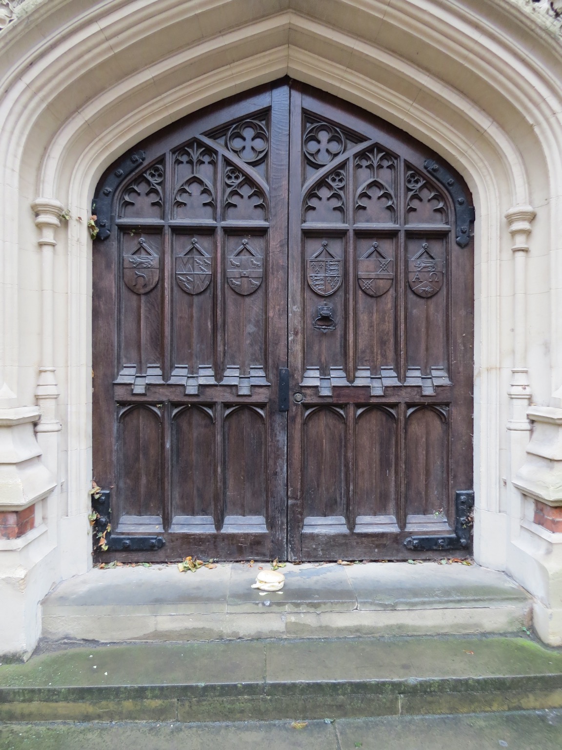Roll containing crisps in front of large, ornate door