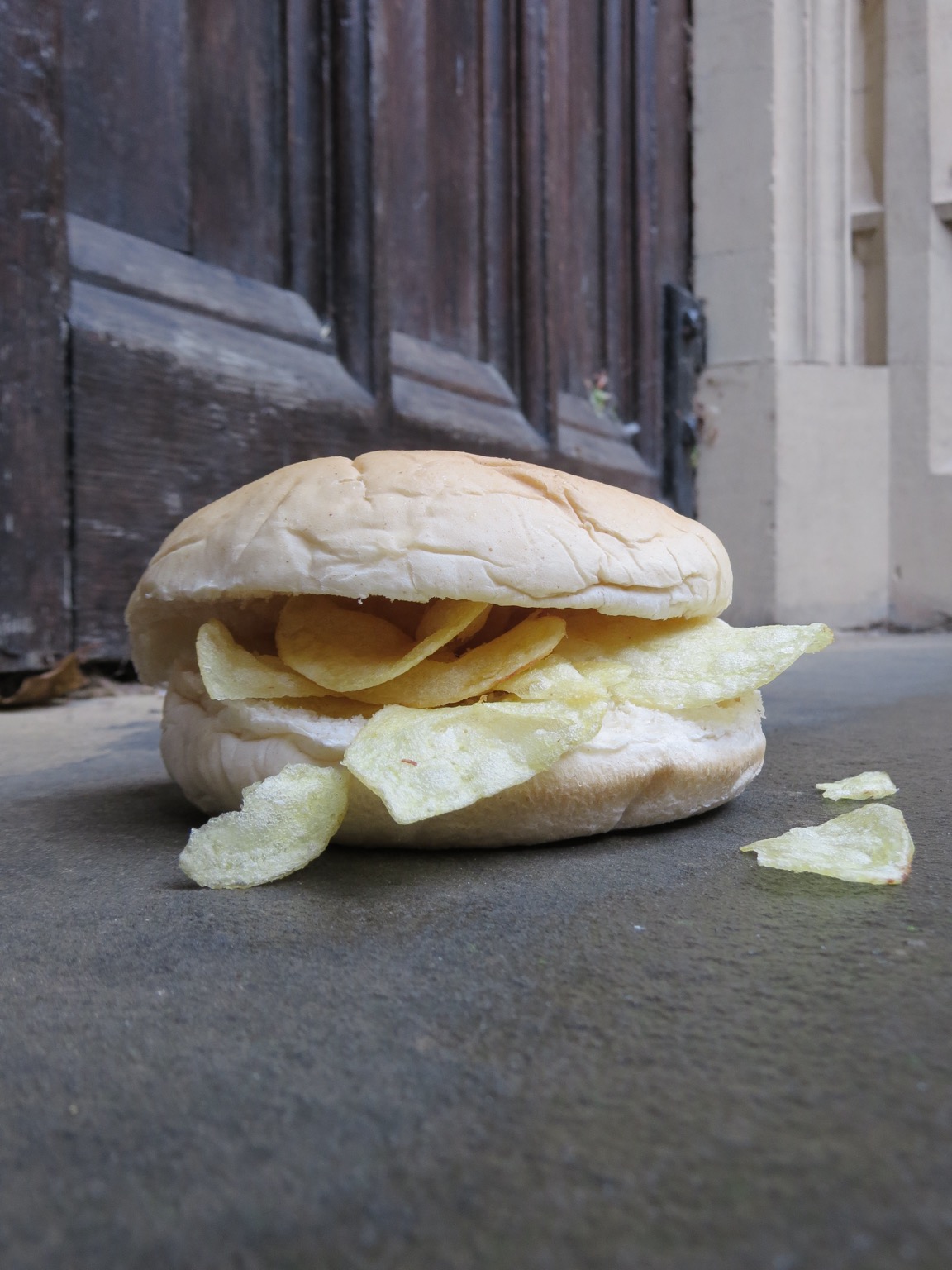Close up of crisp-filled roll on a doorstep