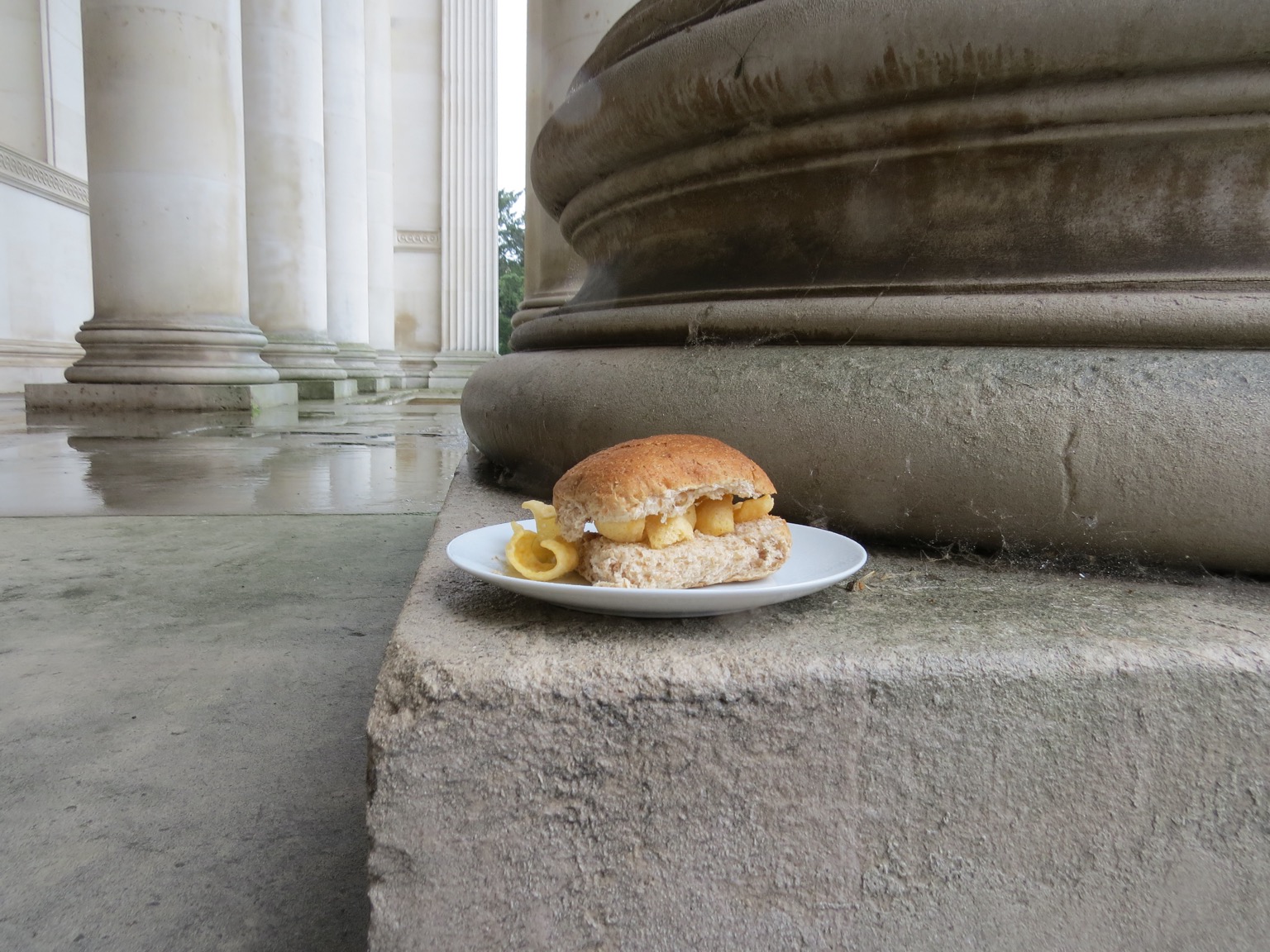 Brown Quavers roll at the foot of a stone column