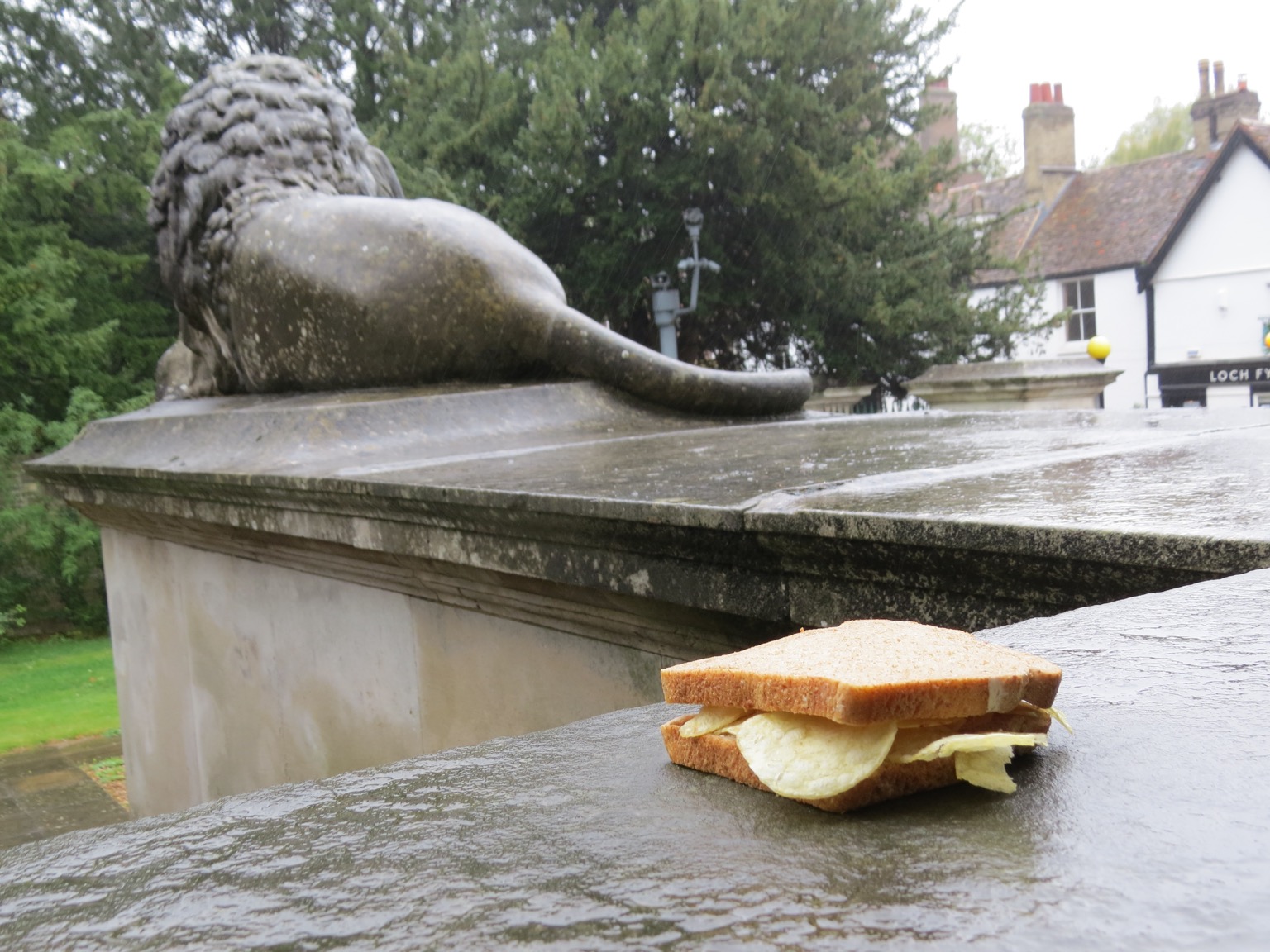 Brown crisp sandwich in front of a lion statue