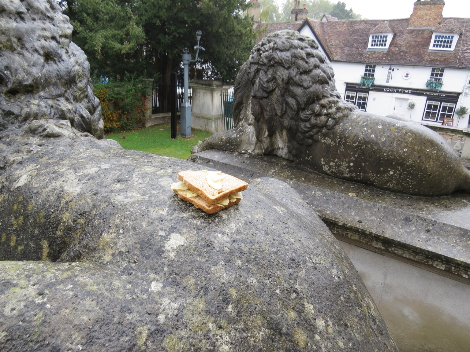 Crisp sandwich on back of lion statue with another behind