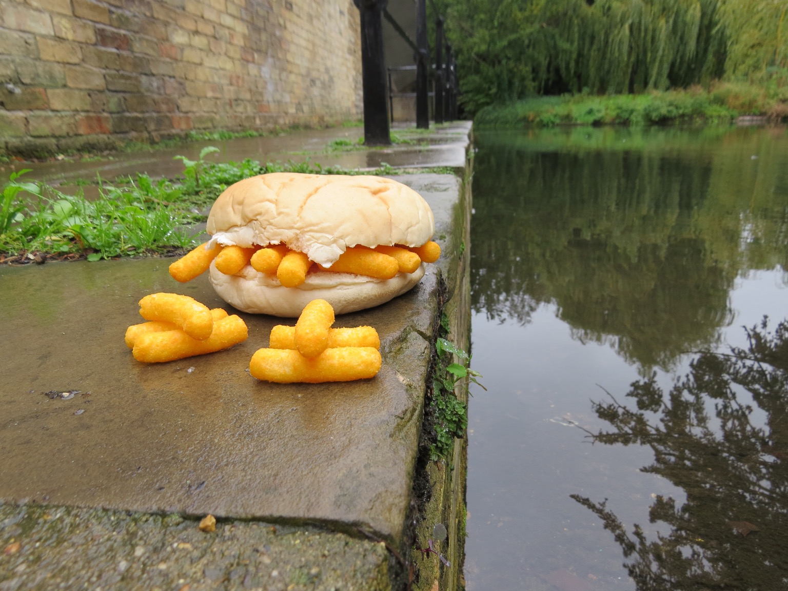 Wotsits in and alongside a roll sat by the water