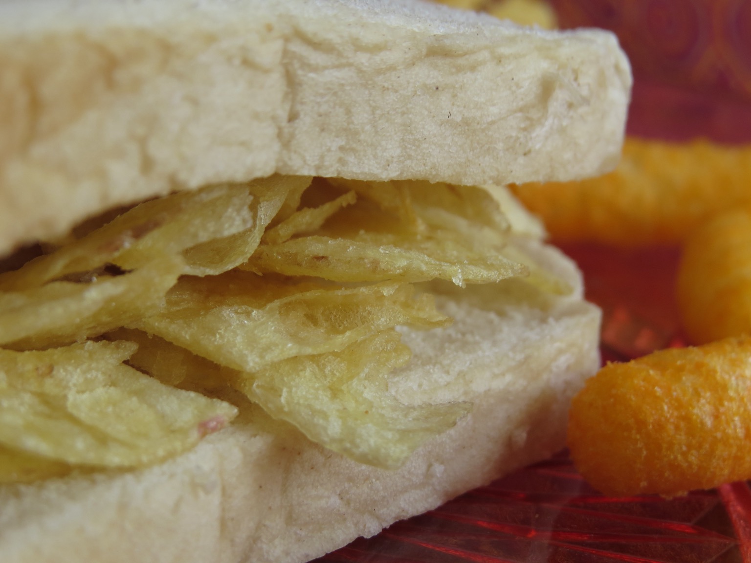 Extreme close up of potato crisp sandwich and Wotsits