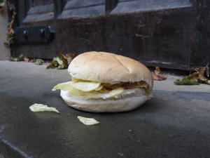 Crisp roll on a wet step in front of a door