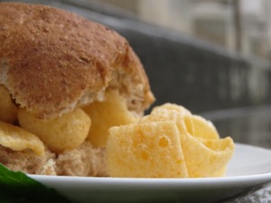 Close up of Quavers within and alongside a brown roll