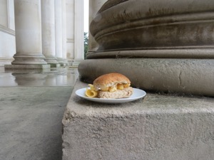 Brown Quavers roll at the foot of a stone column