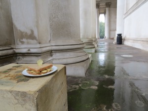 Crisp sandwich with crisp stuck in it in front of columns