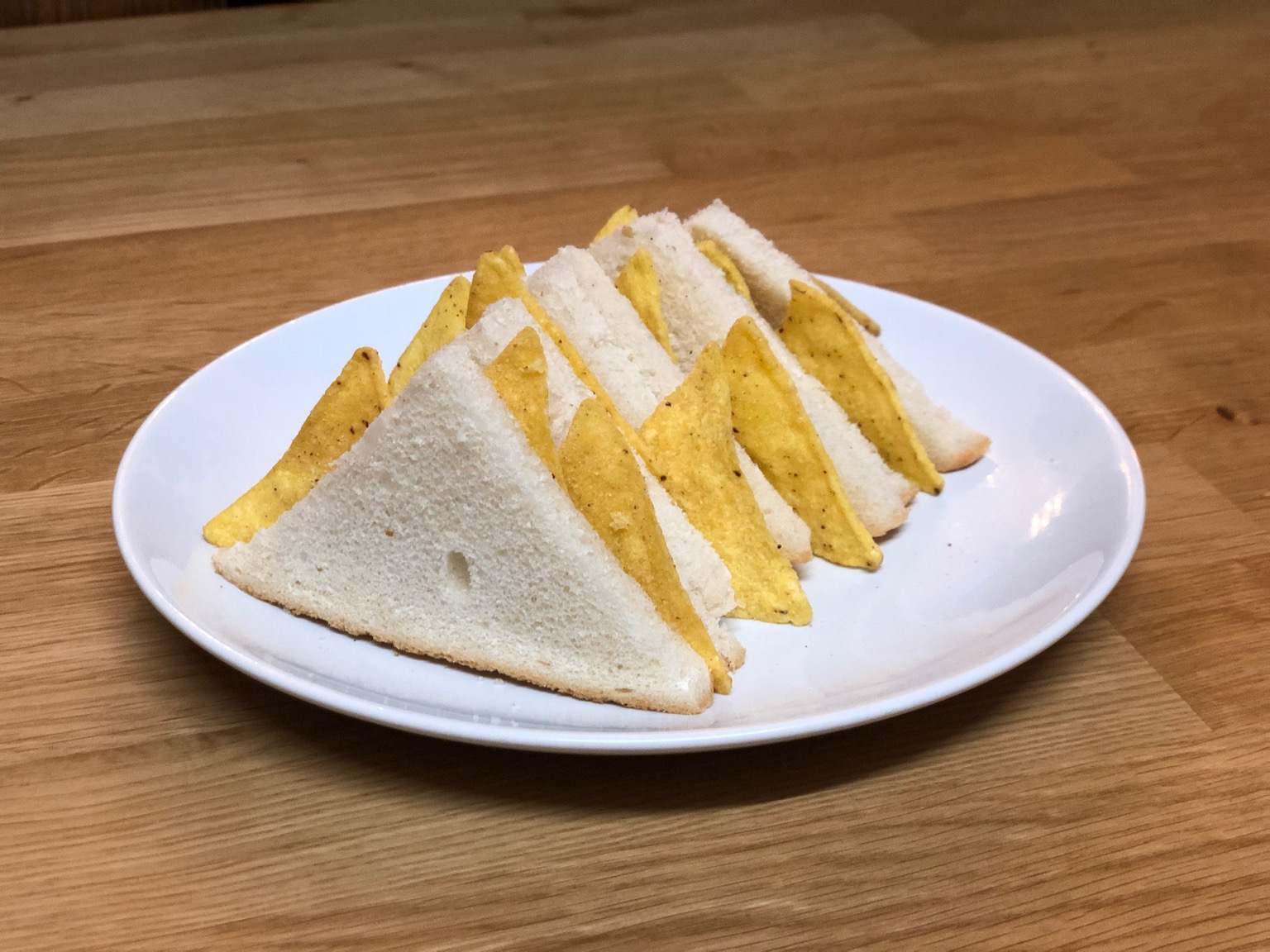 Small diagonally-cut white Dorito sandwiches
