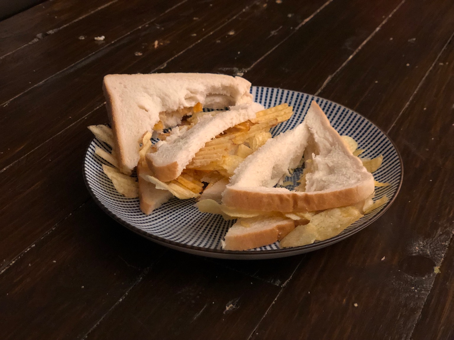 Diagonally-cut crisp sandwich torn apart