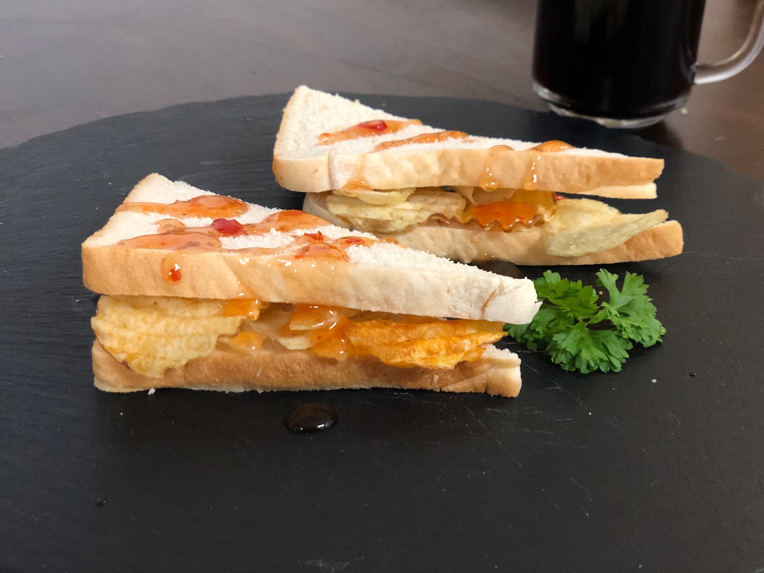 Garnished diagonally-cut crisp sandwich