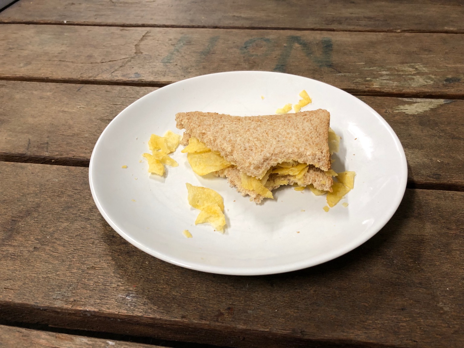 Partially-eaten brown crisp sandwich