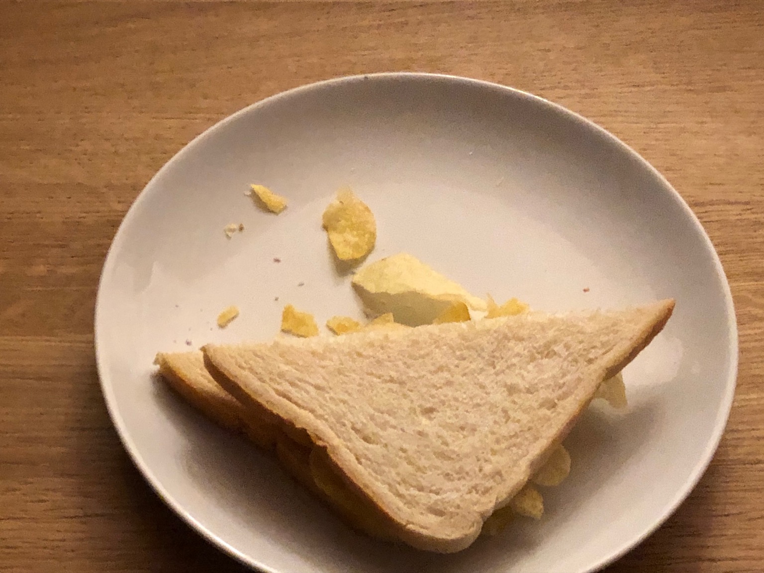 Half of a diagonally-cut white crisp sandwich