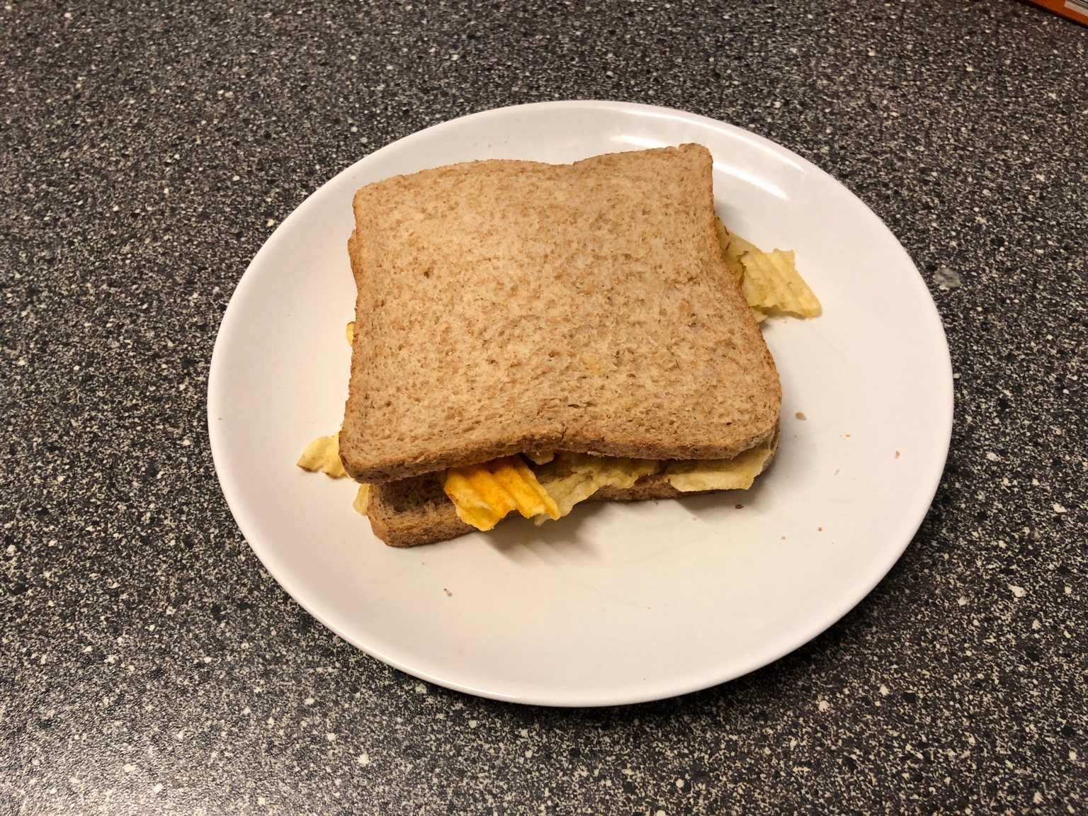 Crinkle-cut crisps in a brown bread sandwich