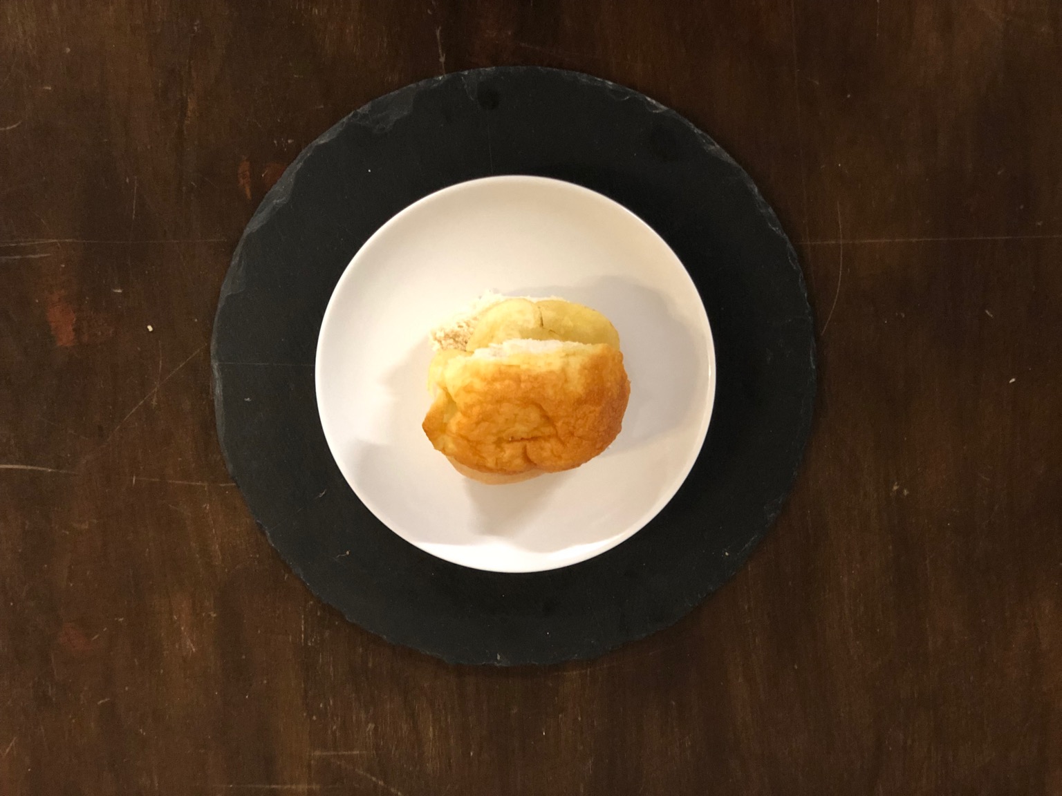 Overhead view of cheese-topped crisp roll