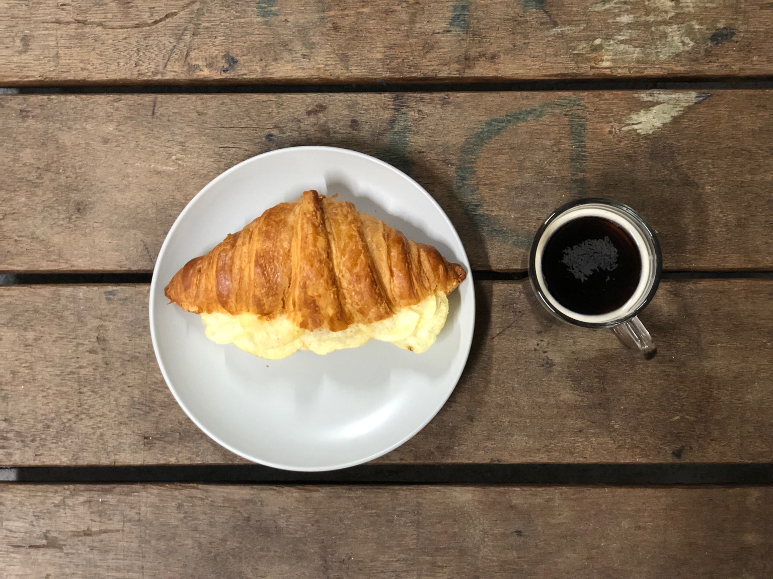 Overhead view of crisp croissant and drink