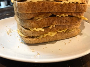 Base of crinkle-cut crisps in layers of brown bread