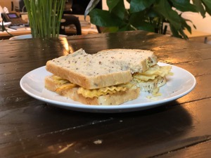 Crinkle-cut crisps in multigrain bread sliced in half