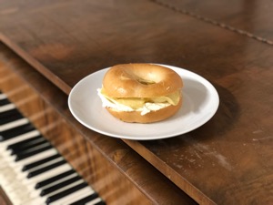 Crisps and cream cheese in a bagel on a piano