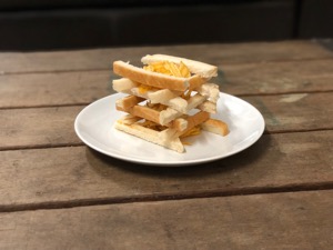 Lattice of bread crusts containing crinkle-cut crisps