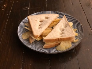 Diagonally-cut crisp sandwich with finger holes