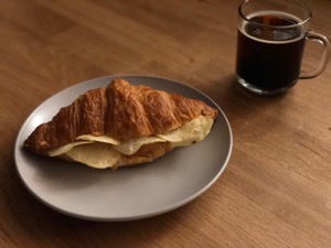 Crisp croissant alongside drink