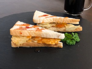 Garnished diagonally-cut crisp sandwich