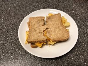 Crinkle-cut crisps in brown bread nearly torn in half