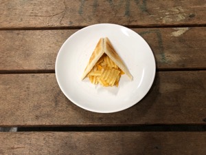 Diagonally-cut toast leaning above crisps