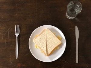 Diagonally-cut crisp sandwich with knife and fork