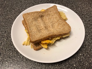 Brown crinkle-cut crisp sandwich with finger marks