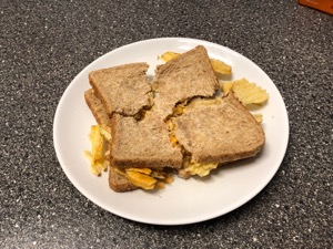 Brown crisp sandwich torn into quarters