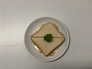 Overhead view of garnished white crisp sandwich