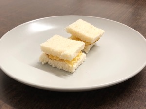 Tiny sandwiches of crinkle-cut crisps in white bread