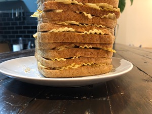 Lower part of a whole brown loaf filled with crisps