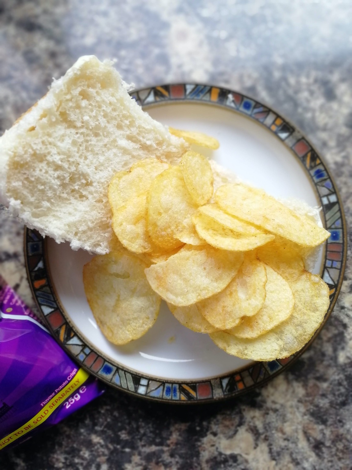 Open white roll with crisps on it and bag visible
