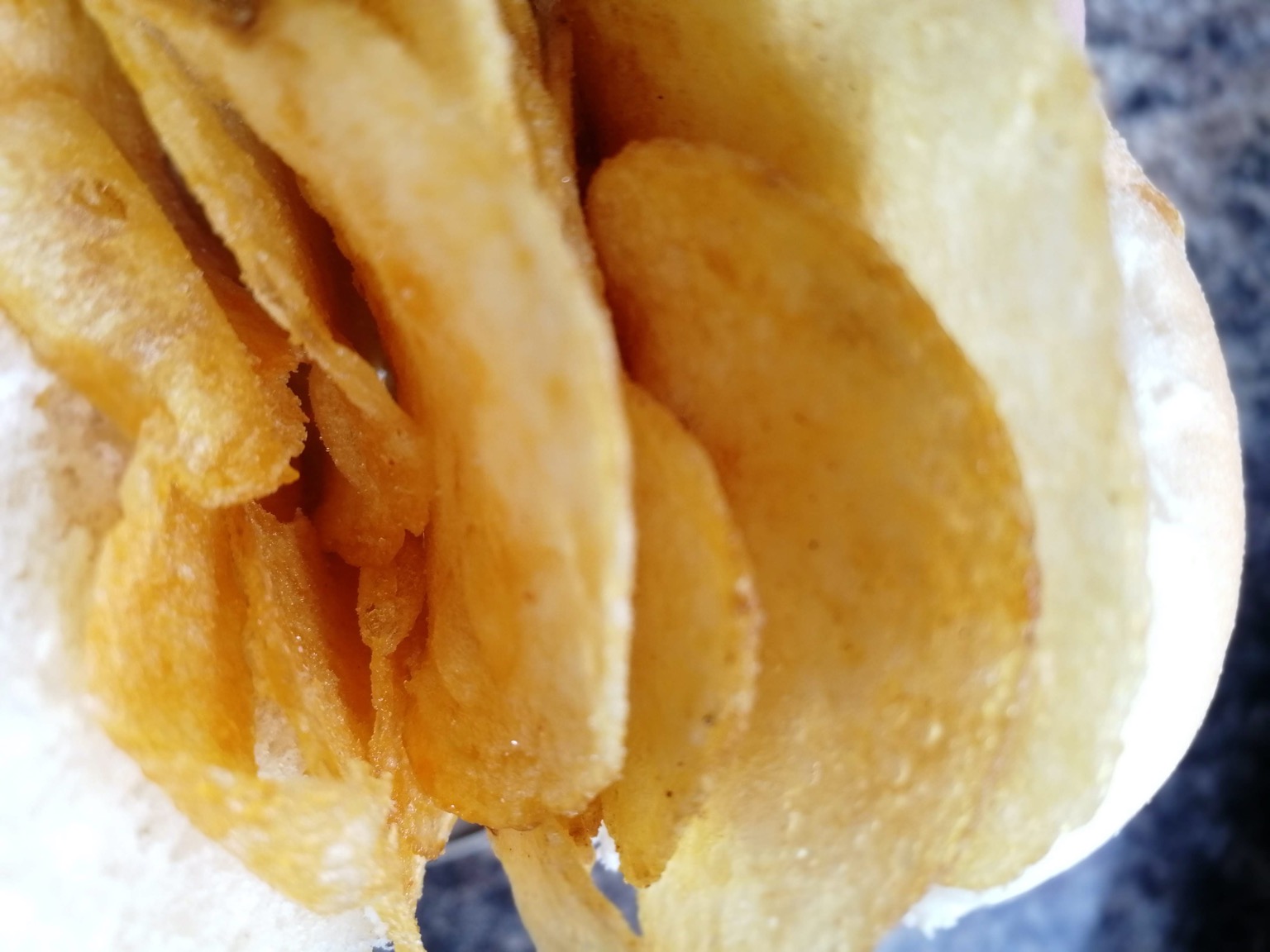 Extreme close up of white roll containing crisps