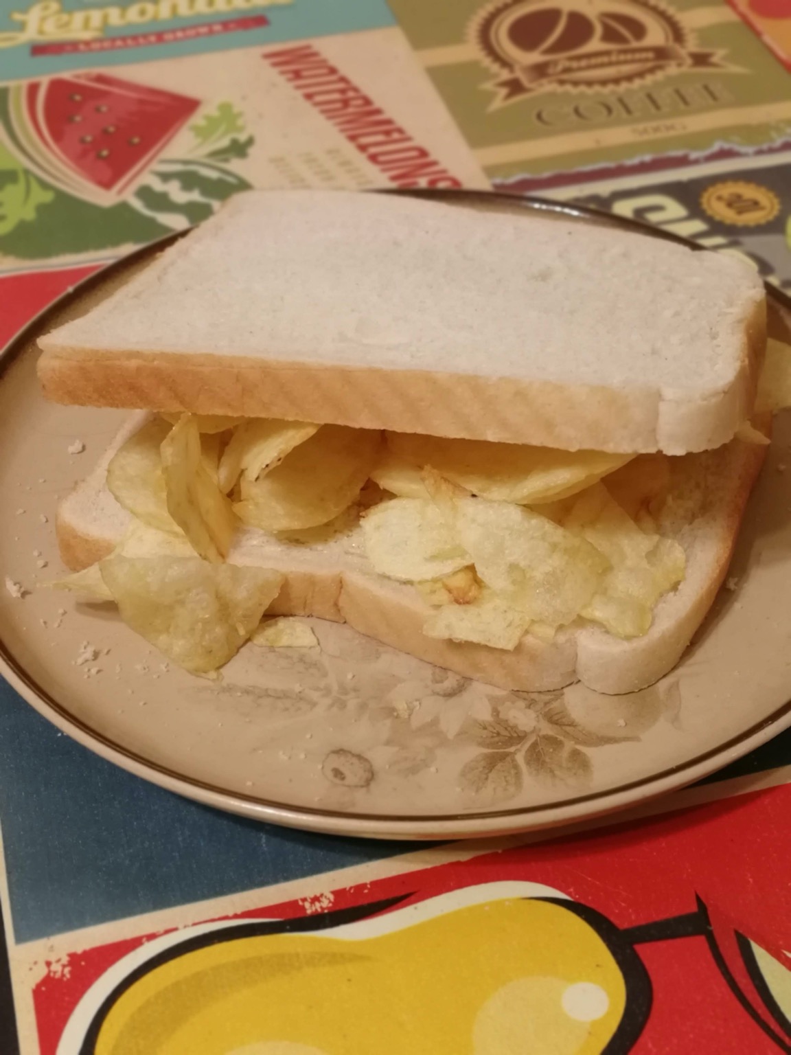 White crisp sandwich on a plate on a decorative tablecloth