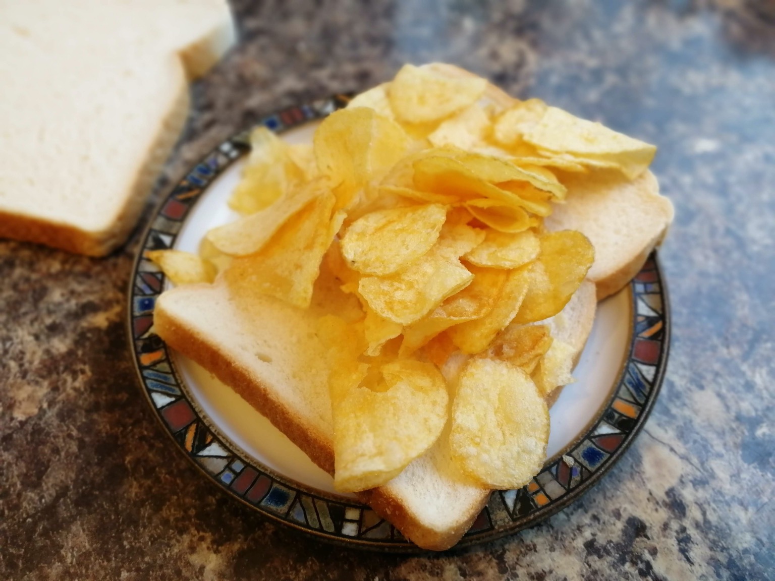 Crisps on sliced white bread with lid off