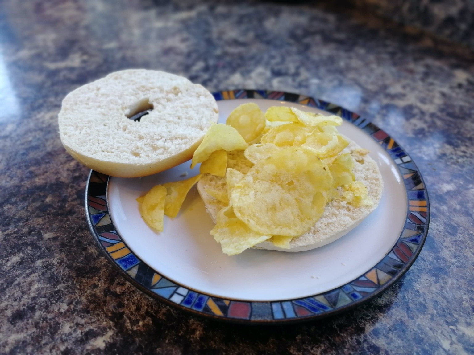 Crisp-filled bagel with lid off on a plate