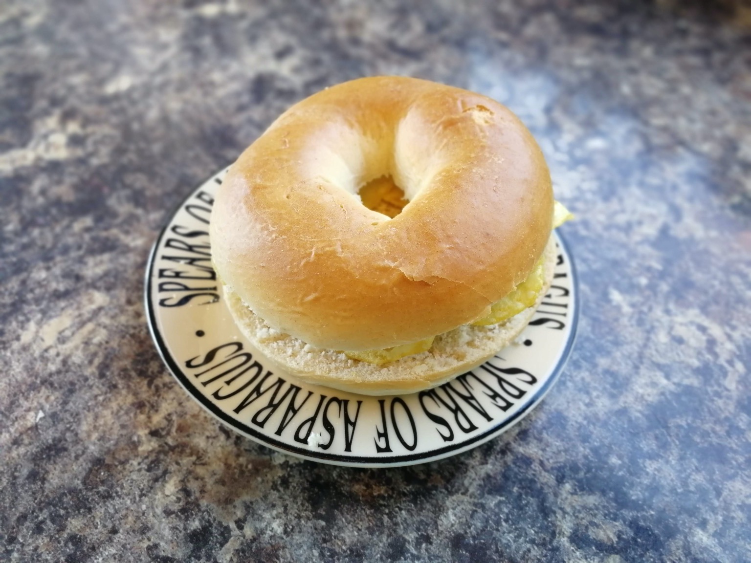Crisp-filled bagel on a typographic plate