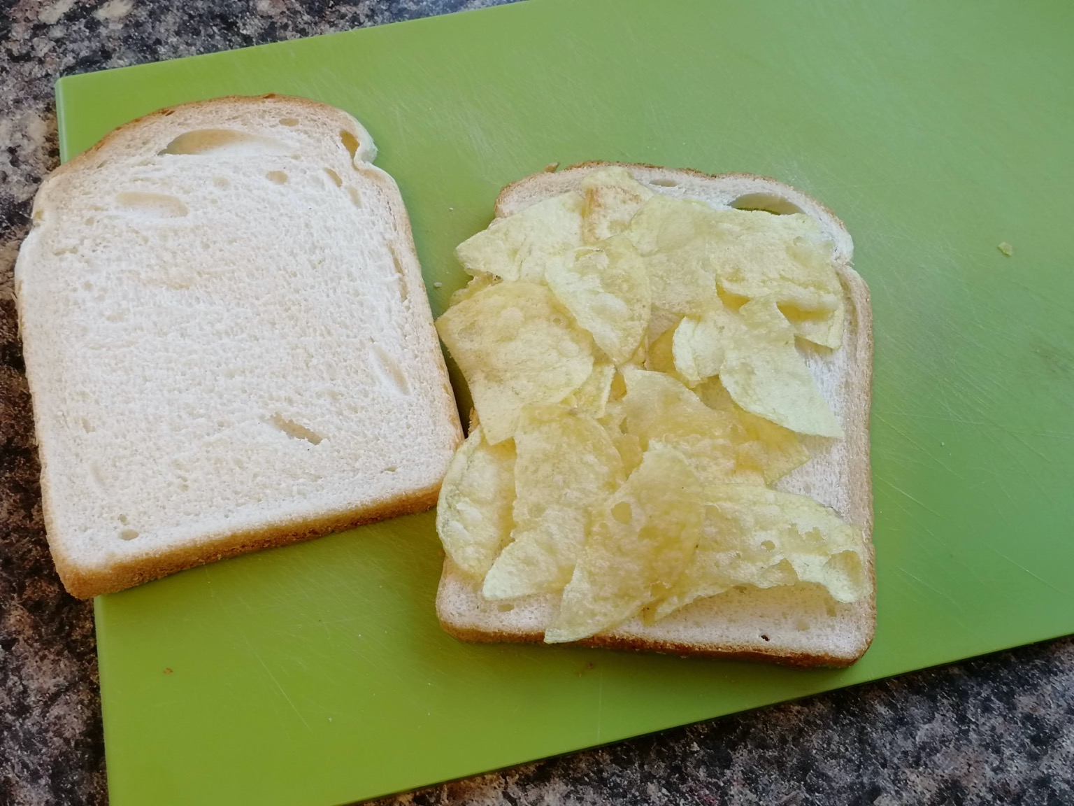 White crisp sandwich with lid off on a cutting board