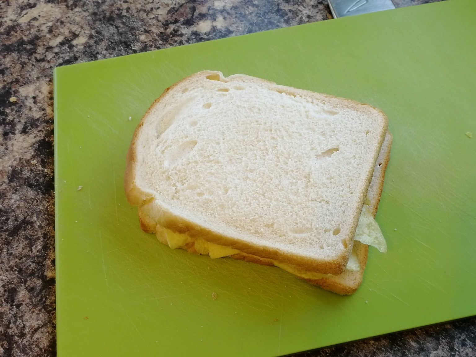 Crisp-filled white sandwich on a cutting board