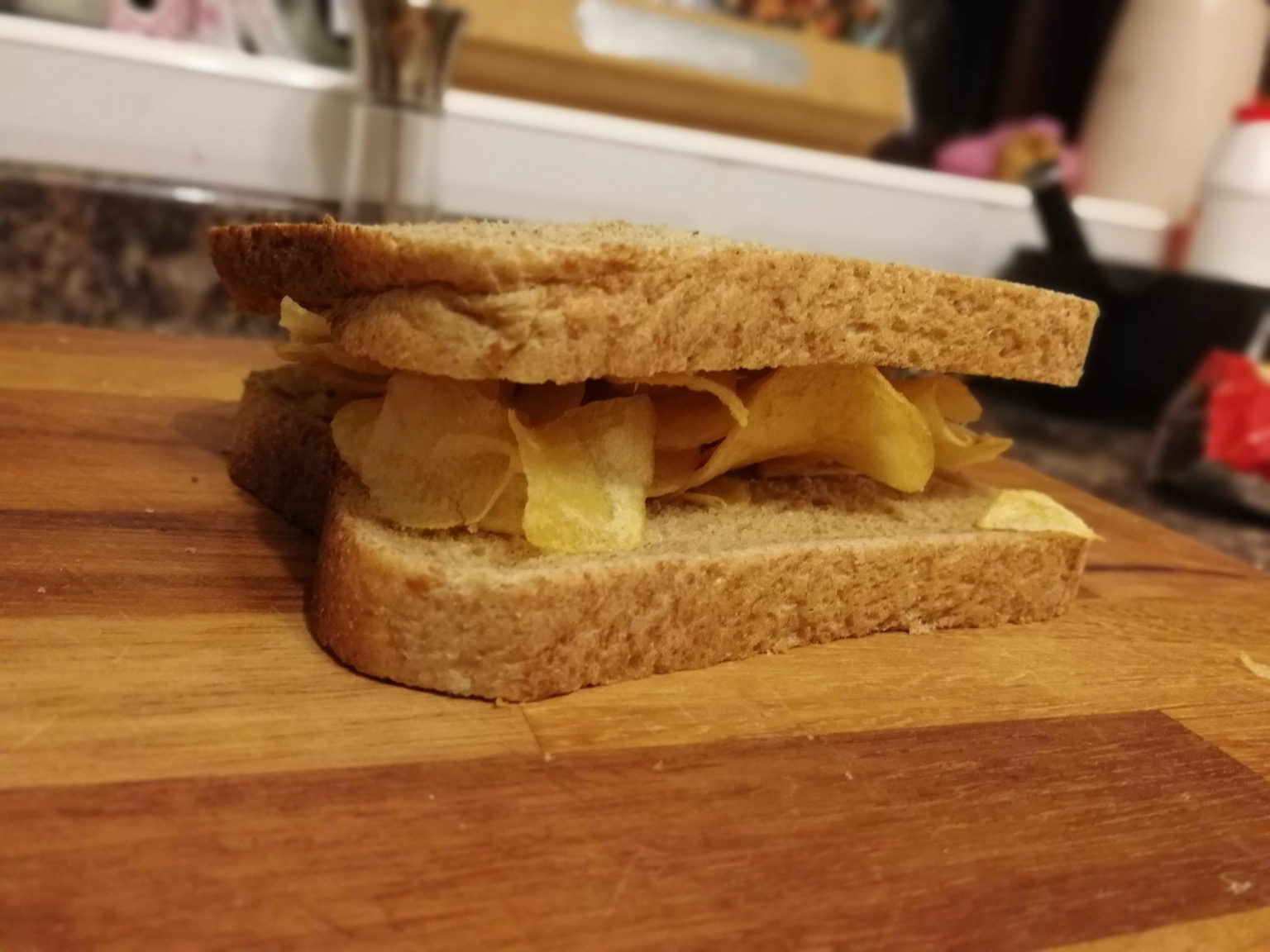 Close up of brown crisp sandwich on chopping board