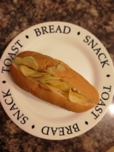 Overhead view of crisp-filled split finger roll on a plate