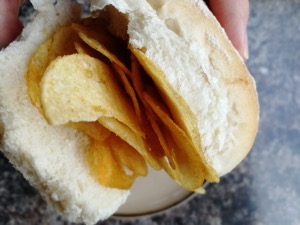 Close up of handheld crisp-filled white roll