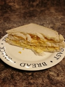 Half of a double decker white crisp sandwich